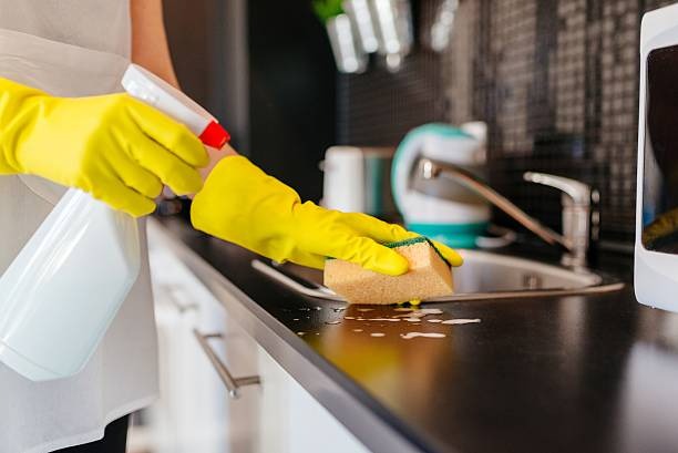 cleaning kitchen with white scrubbing pad